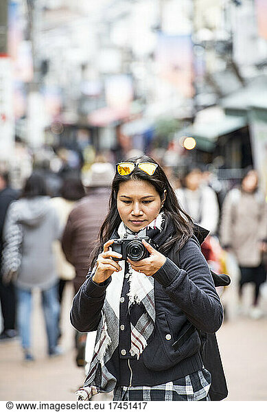 woman taking a picture with digital mirrorless camera