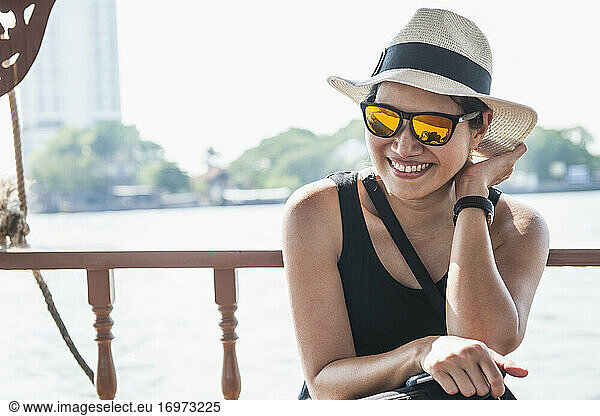Woman taking a river cruise on Bangkok's Chao Phraya river