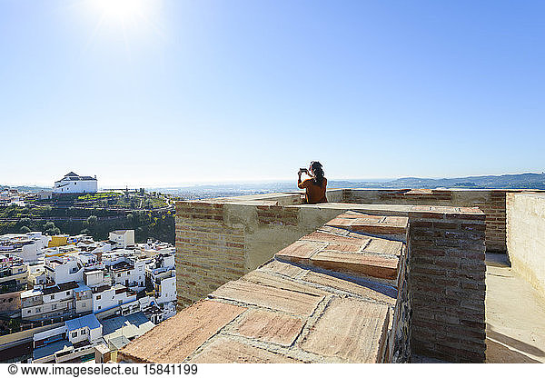 Woman taking photos from the Alcazaba of Velez Malaga  Malaga  S