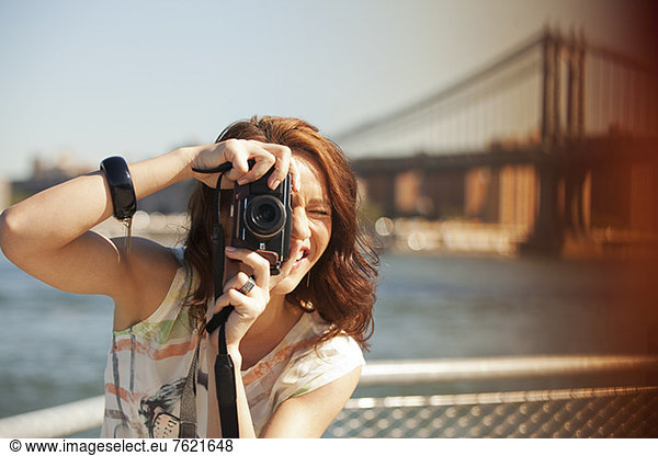 Woman taking picture by city cityscape