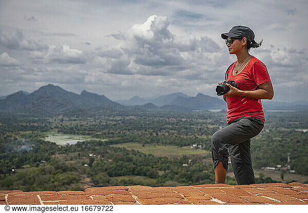 Woman taking picture on the top of the rock fortress of Sigiriya