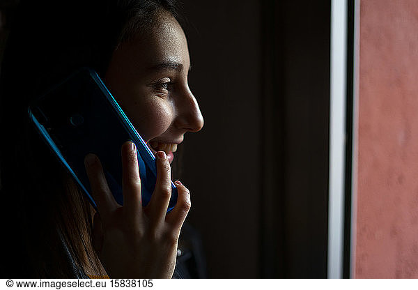 Woman talking on the phone at home.