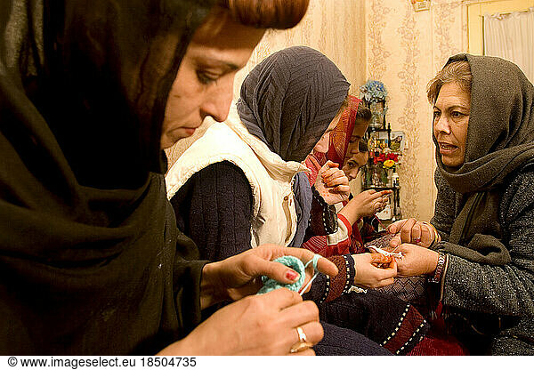 Woman teaches others how to crochet in Kabul.
