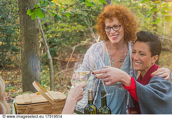 WOMAN TOASTING EACH OTHER in the woods