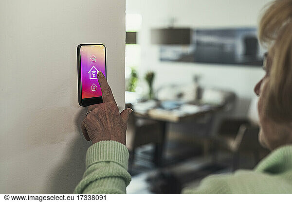 Woman touching wifi icon on home automation device
