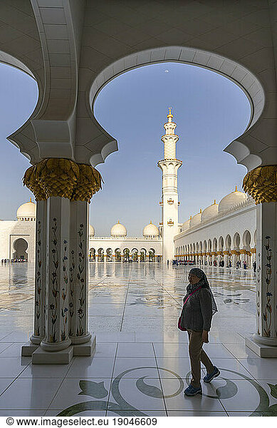Woman tourist with Minaret in the background in Sheikh Zayed Mosque