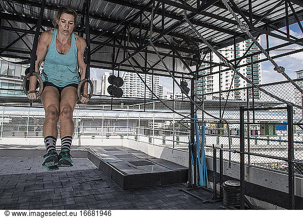 woman training at rooftop gym in Bangkok
