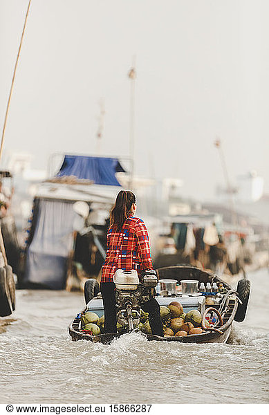 Woman transporting fresh fruit in motorboat  Cai Rang Floating Market; Can Tho  Vietnam