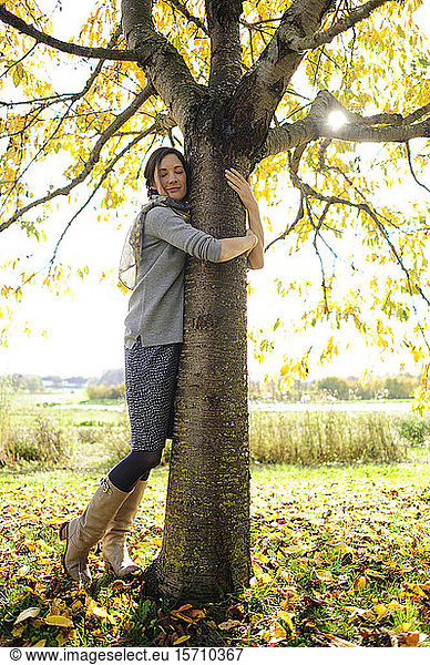 Woman tree hugging