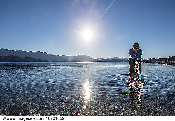 Woman trying the water at Nahuel Huapi Lake in Patagonia