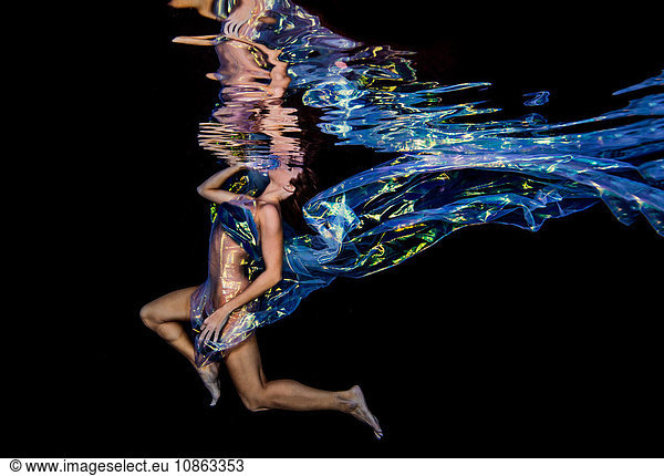 Woman underwater in jellyfish fabric