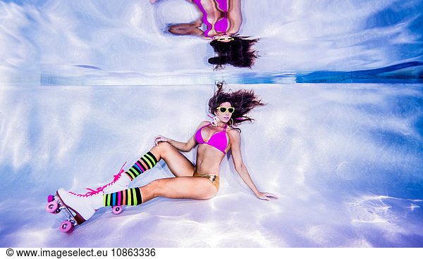 Woman underwater on roller skates