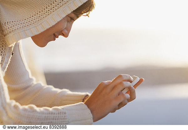 Woman using cell phone outside