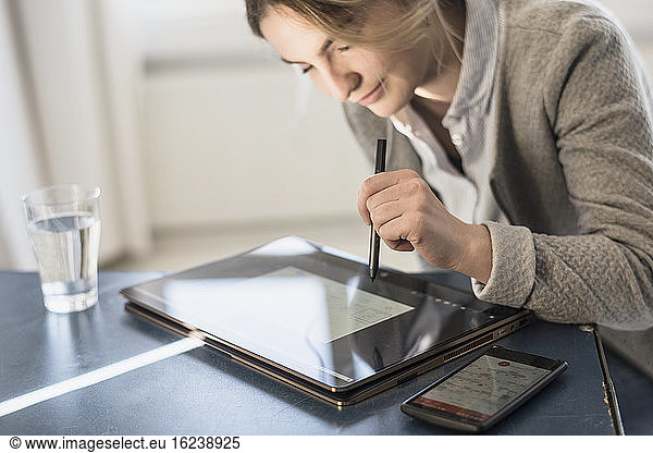 Woman using laptop with touch screen
