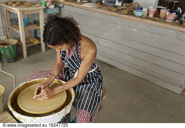 Woman using potters wheel