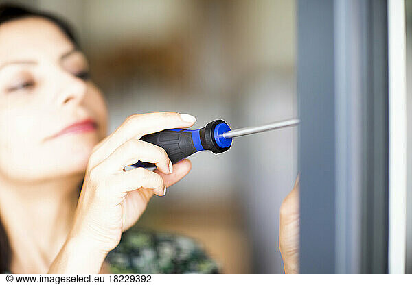 Woman using screwdriver
