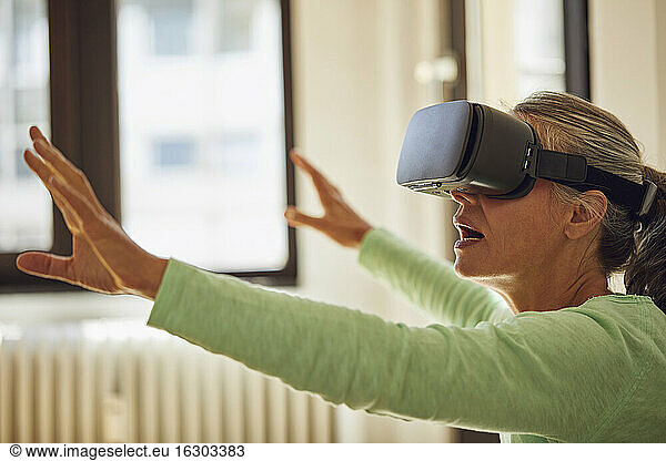 Woman using VR glasses at home