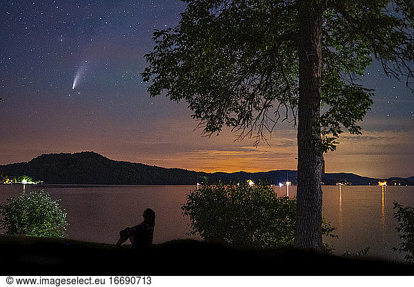 Woman views the comet Neowise over Vermont's Lake Bomoseen