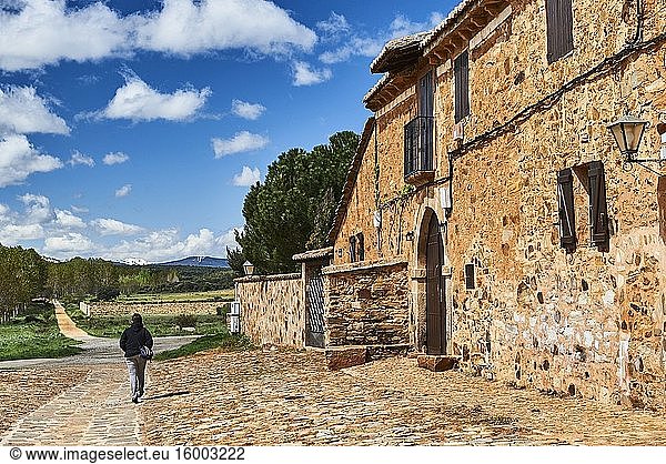 Woman walking along medieval streets of Castrillo de los Polvazares (Leon province  region of Castilla y Leon  Spain)