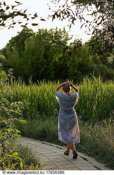 Woman walking among green meadow and grass  relaxing rice up