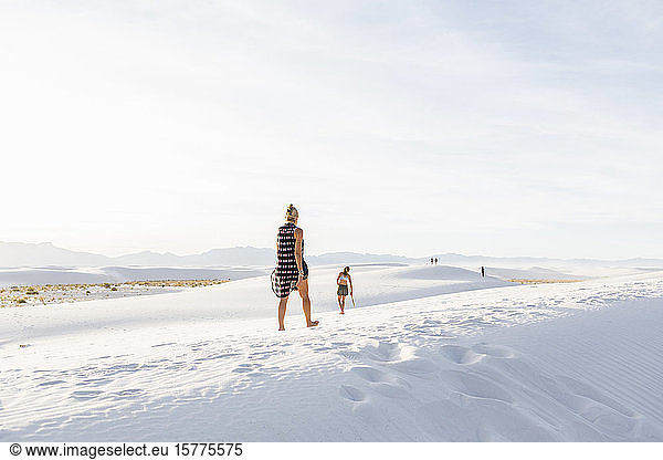 Woman walking in white sand dunes