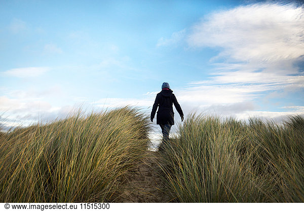 Woman walking on dune