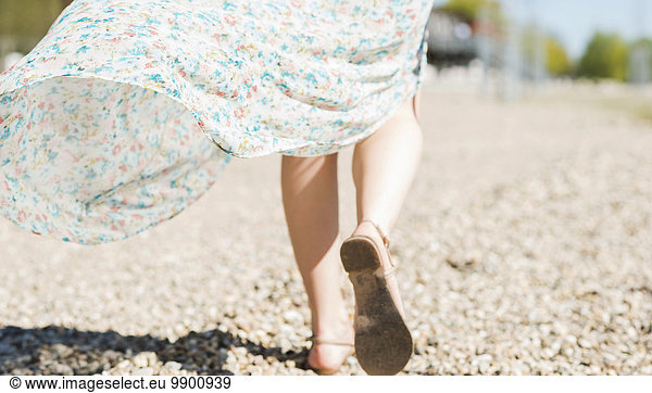 Woman walking on shingle beach