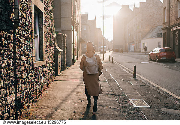 Woman walking on street, Edinburgh, Scotland