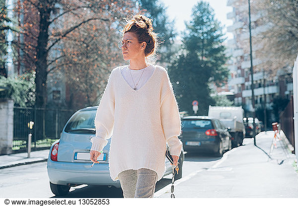 Woman walking on sunny street  Milan  Italy