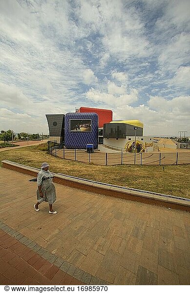 Woman walking past Soweto Theatre in Soweto township  South Africa