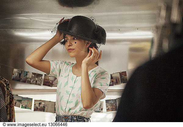Woman wearing black hat while standing in camper van