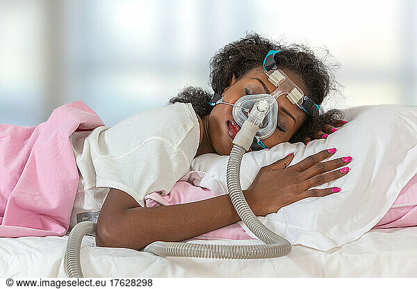 Woman wearing CPAP headgear mask for sleeping