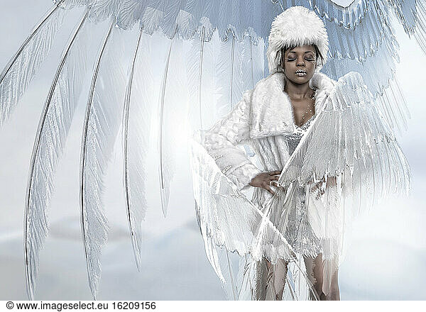 Woman wearing fur coat and angel costume