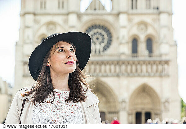 Woman wearing hat contemplating on vacation