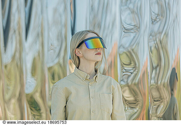 Woman wearing smart glasses in front of metal structure
