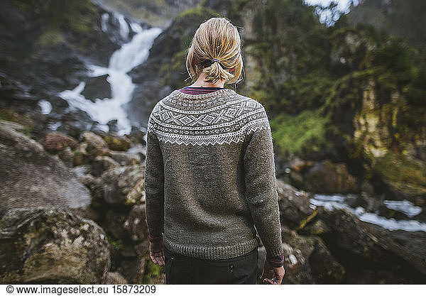 Woman wearing sweater by Latefossen waterfall in Vestland  Norway