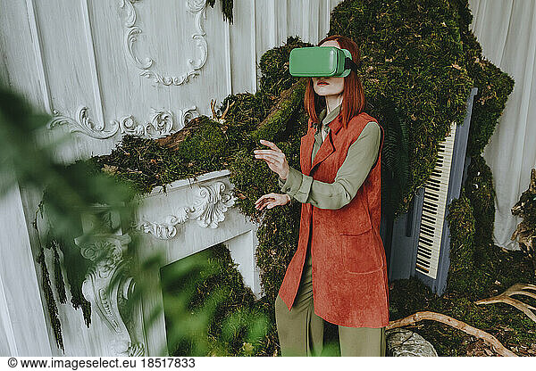 Woman wearing virtual reality simulator standing in abandoned place