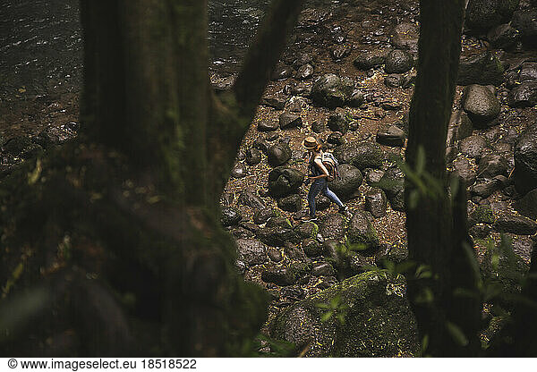 Woman with backpack walking in forest