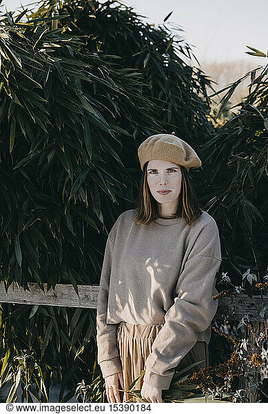 Woman with barret standing in garden