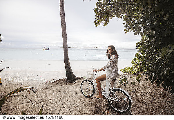 Woman with bicycle on the beach  Maguhdhuvaa Island  Gaafu Dhaalu Atoll  Maldives