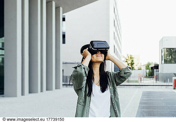 Woman with black hair wearing virtual reality simulator