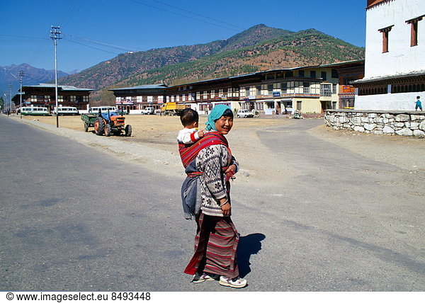 Woman with child in sling  Paro  Bhutan