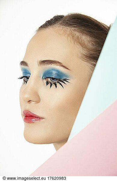 Woman with creative make-up posing in studio