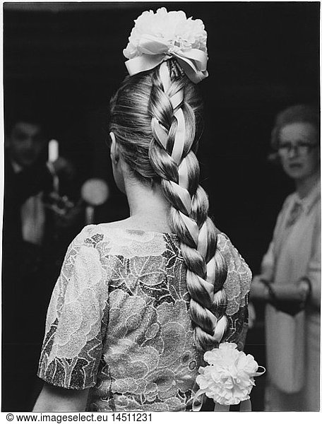Woman with Fashionable Long Braid Entwined with Ribbon and Large Flowers Decorating the Crown and End of Braid  1965