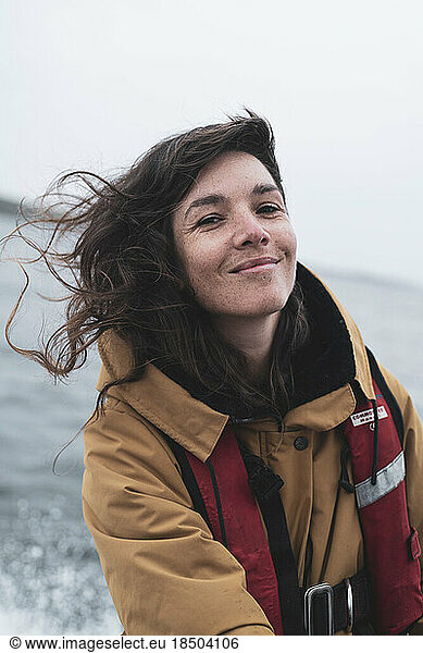 woman with freckles smiles on boat ride through scottish islands