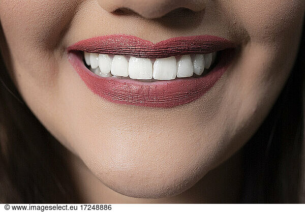 Woman with red lipstick and toothy smile