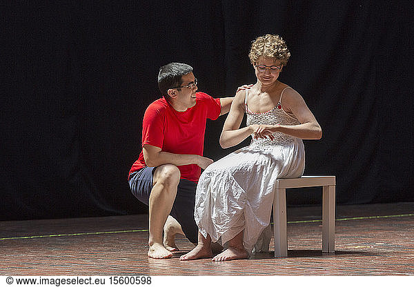 Woman with Sjogren-Larsson Syndrome and man with Autism performing on stage