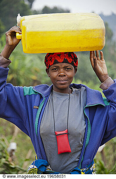 Woman with water jug on her head in Rwanda