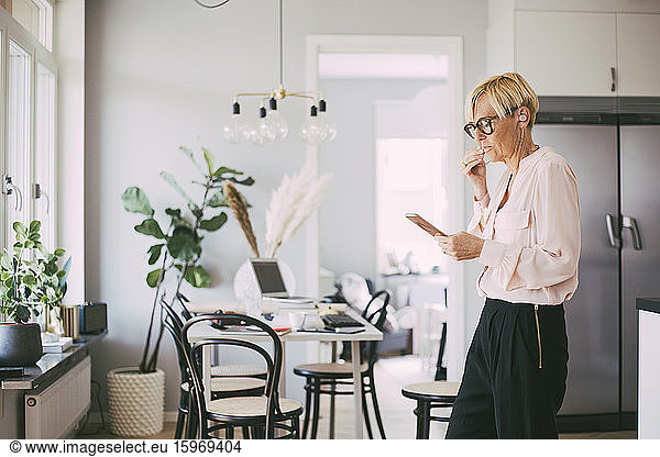 Woman working from home talking on the phone