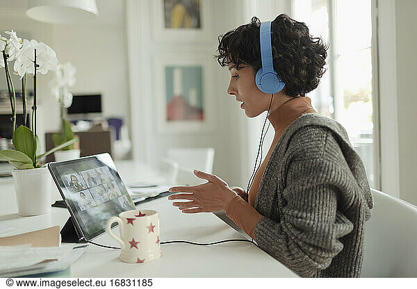 Woman working from home video conferencing at digital tablet